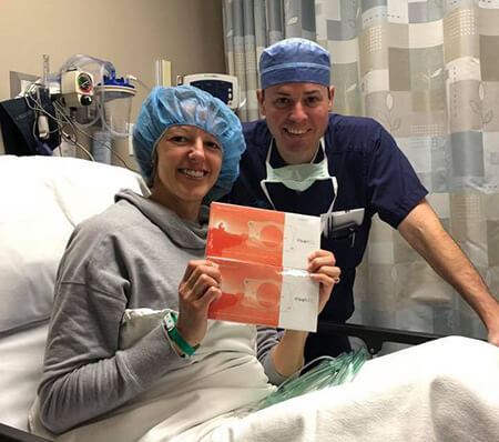 Dr. Parkhurst with a Patient Dr Parkhurst standing by Patient laying in bed
