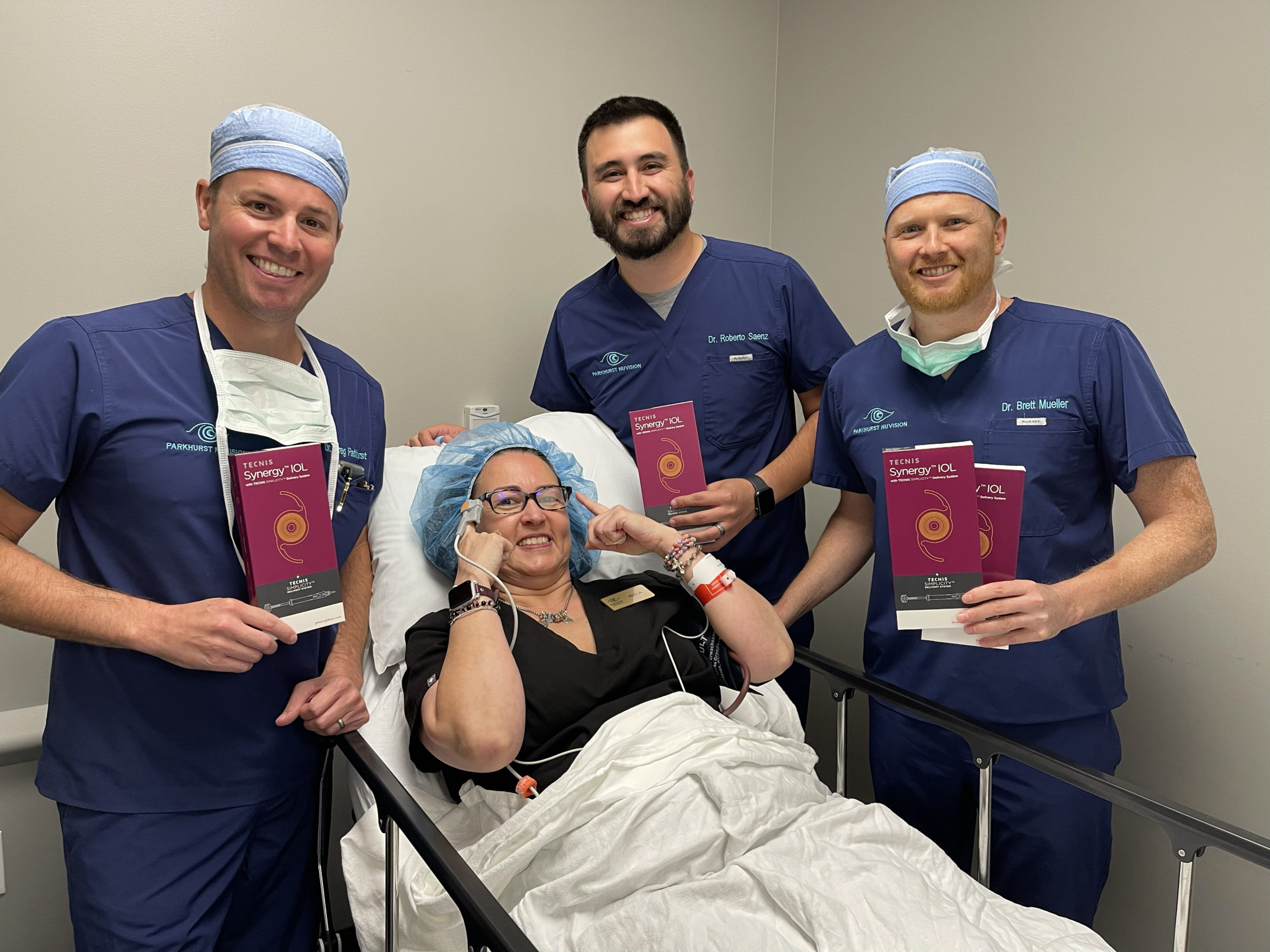 3 doctors around a patient laying in bed