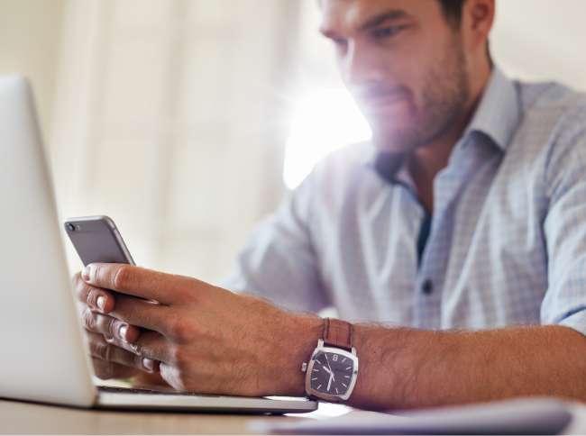 man watch laptop smartphone