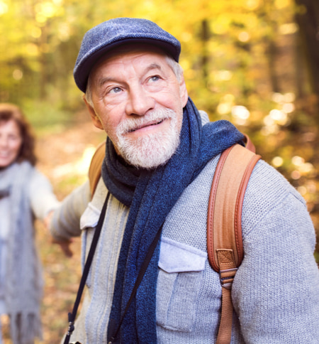 senior walking outside with restored vision after cataract surgery