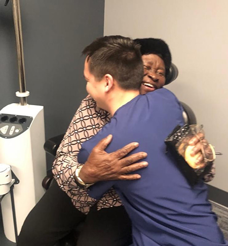 Dr. V hugging a very happy patient during a cataract surgery follow-up