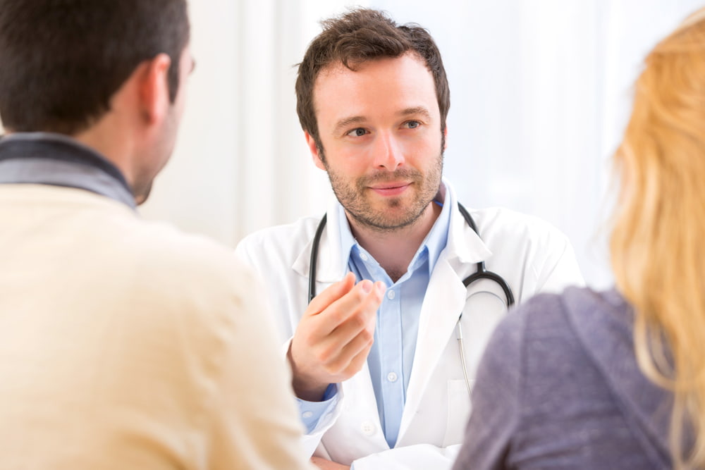 Couple meeting with a doctor in his office
