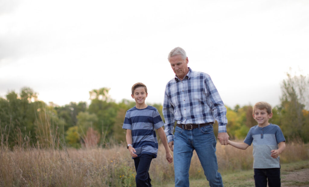 Grandpa walking with his grandsons