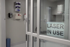laser suite with sign in the window that says laser in use