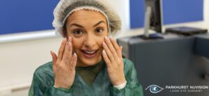 woman wearing a surgical hat and gown with her hands up near her face & company logo